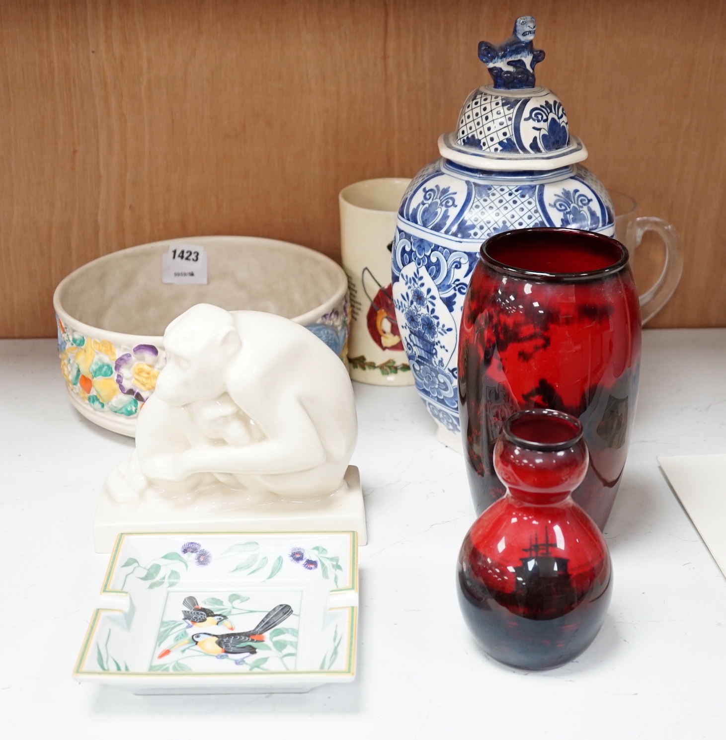 Two Royal Doulton flambé vases, a Wedgwood monkey, a Clarice Cliff bowl, a Crown Devon musical hunting mug, etc., tallest flambé vase 22cm